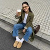 image:imageCUSHIONAIRE Casey Genuine Suede Moccasin Slippers for Women Cozy House Shoes with Moc Toe and Penny Loafer StrapSand