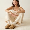 image:imageCUSHIONAIRE Casey Genuine Suede Moccasin Slippers for Women Cozy House Shoes with Moc Toe and Penny Loafer StrapSand